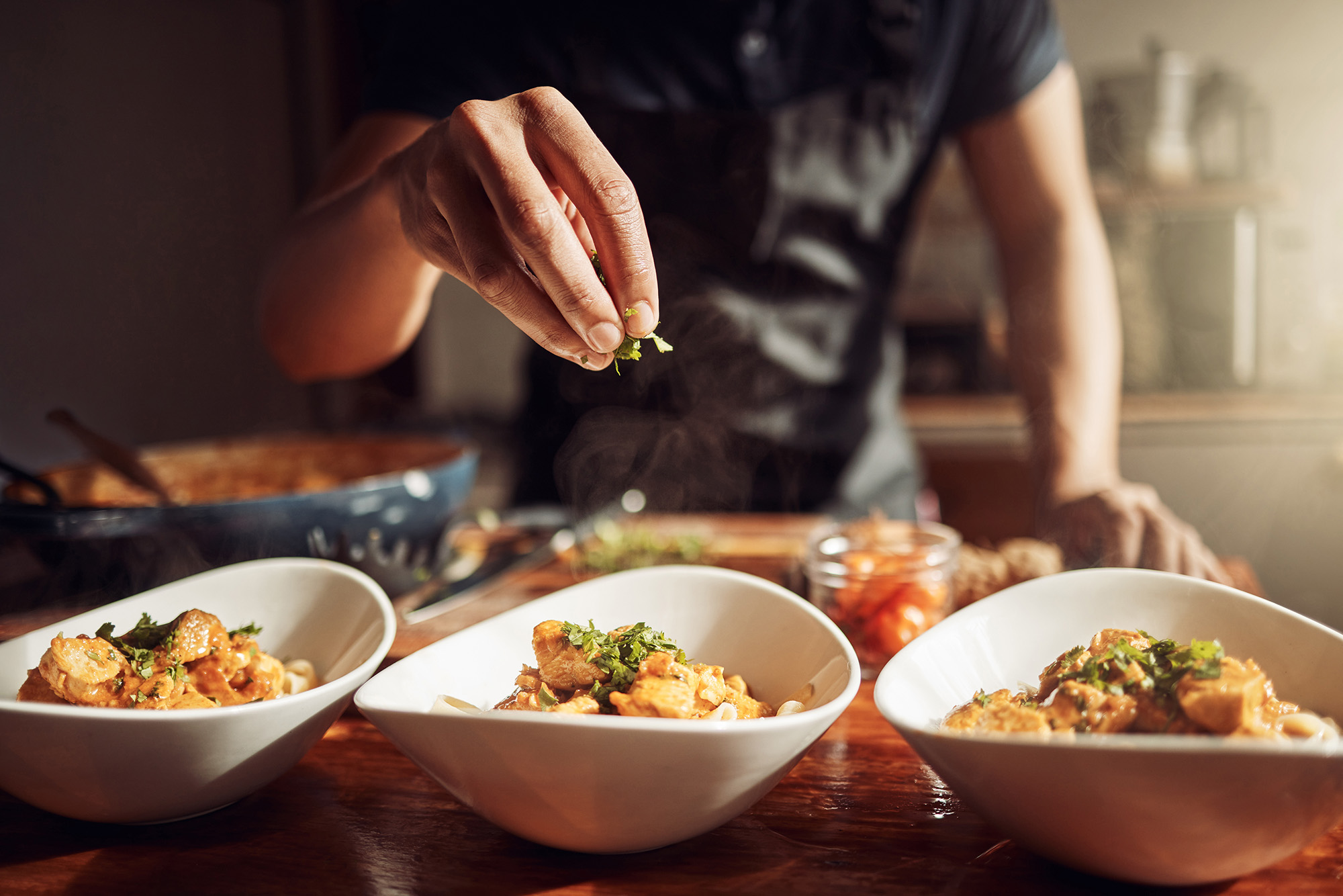 Closeup of man preparing a meal in kitchen at Ironwood apartments