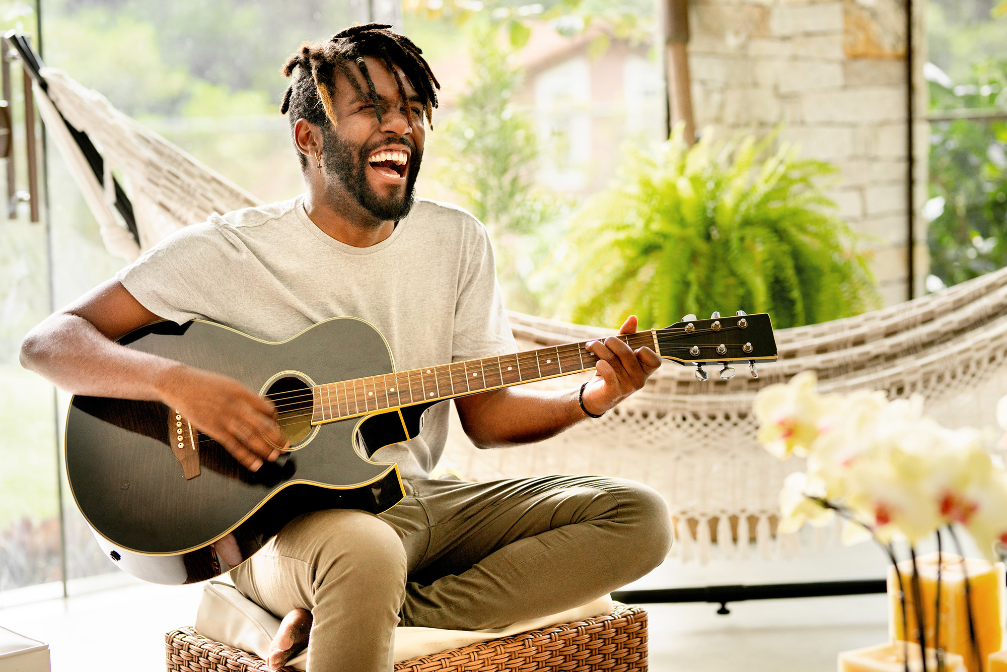 Man smiling and playing acoustic guitar