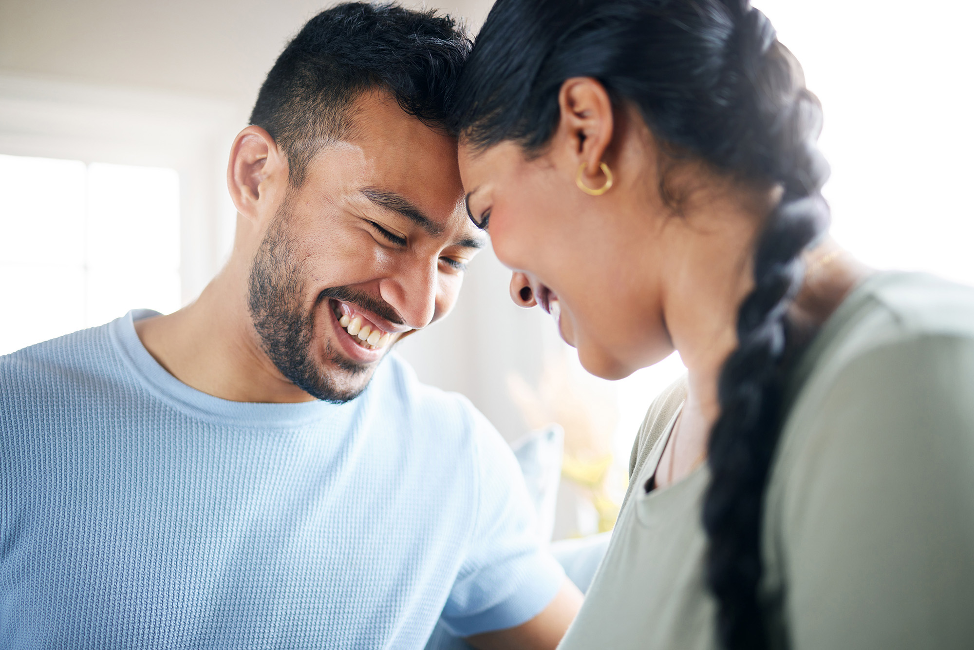 Happy young couple touching heads