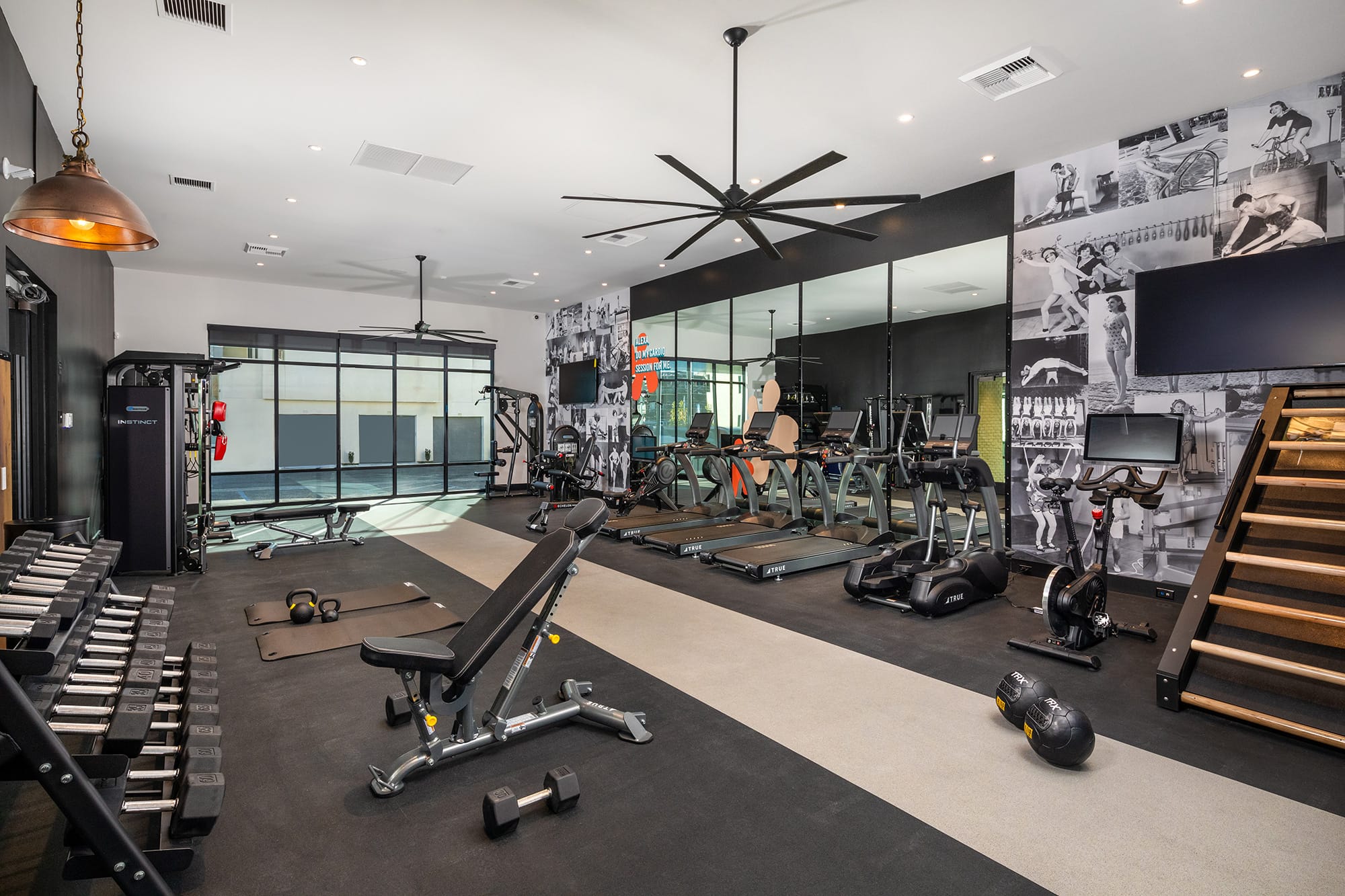 The fitness center at our apartments for rent in San Diego, featuring free weights and exercise equipment.