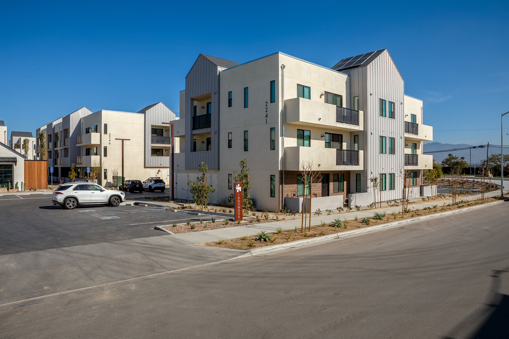 The exterior of the Ironwood Apartments in South San Diego, featuring a modern facade and a view of the parking spots.