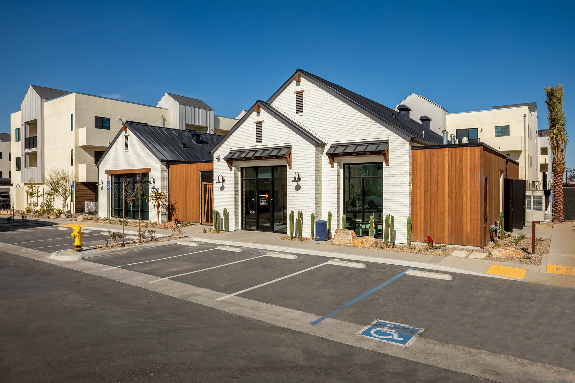 The exterior of the Ironwood Apartments in South San Diego, featuring a modern facade and a view of the parking spots.